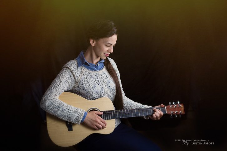 © 2016 Thousand Word Images by Dustin Abbott This is a B-roll shot from an album shoot that I've been working on the last couple of days. My younger sister is a recording artist working on her fifth album! She has this sweet little "mini-Martin" that we wanted to work into the shoot. I used fixed lights in Westcott softboxes in a studio setting. The haze was added in post to give some warmth and color variation to the shot. I'm becoming more familiar with the nuances of the 5DsR. You can see my first video on it here: http://bit.ly/28XKjG4. The amount of resolution it produces is really overkill for portrait settings, IMO. Technical Information: Canon EOS 5DsR + Tamron SP 45mm f/1.8 Di VC USD, Processed in Adobe Lightroom CC, Photoshop CC, and Alien Skin Exposure X (use code "dustinabbott" to get 10% off) Want to know more about me or make contact? Take a look at my website and find a lot of ways t
