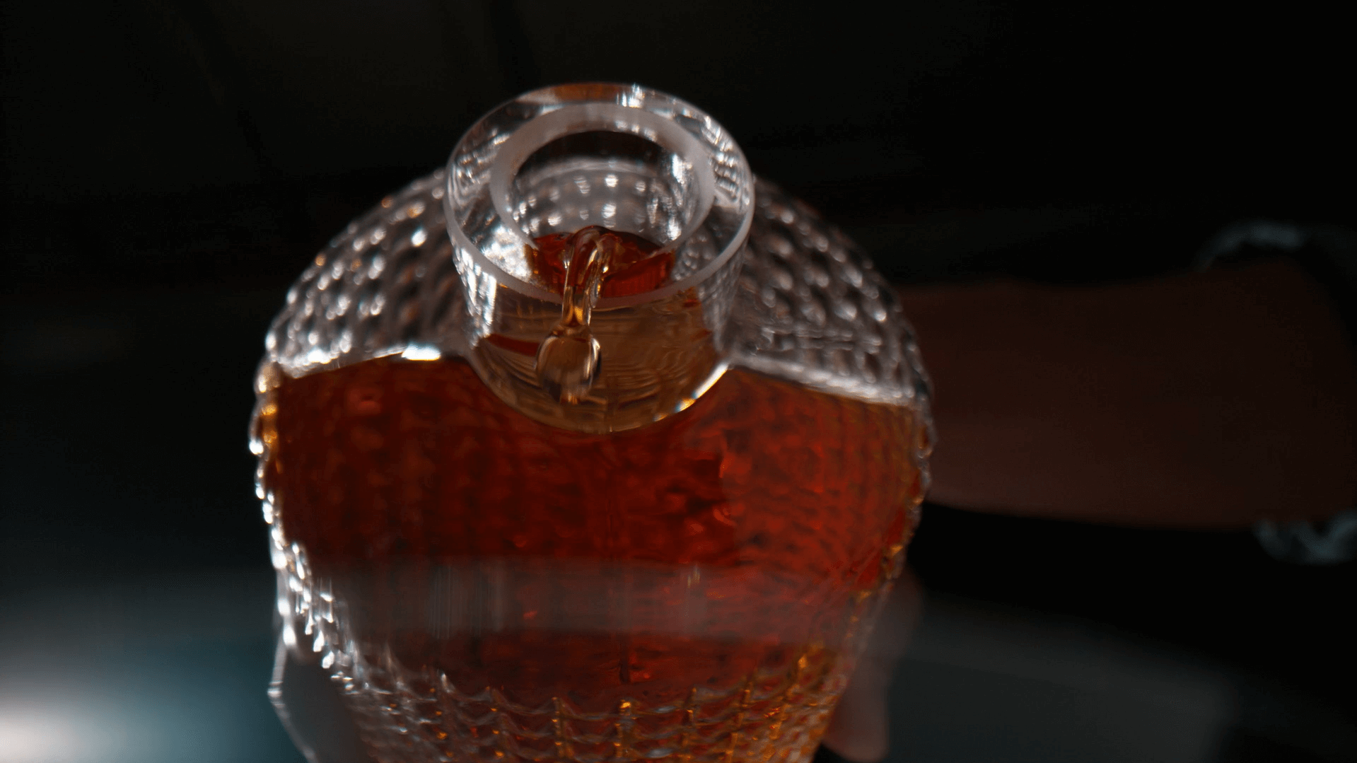 A glass bottle with liquid in it Description automatically generated