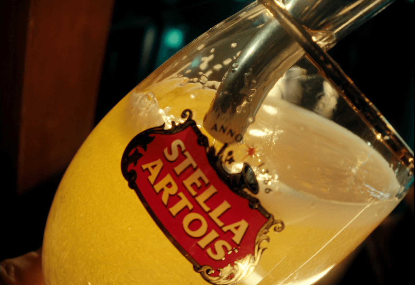 A glass with a liquid in it Description automatically generated