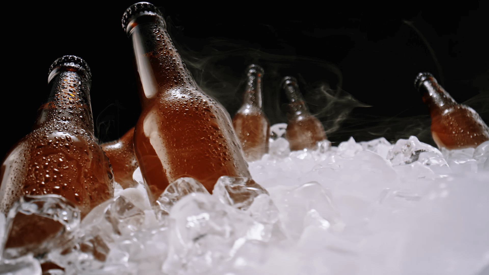A group of bottles in ice Description automatically generated
