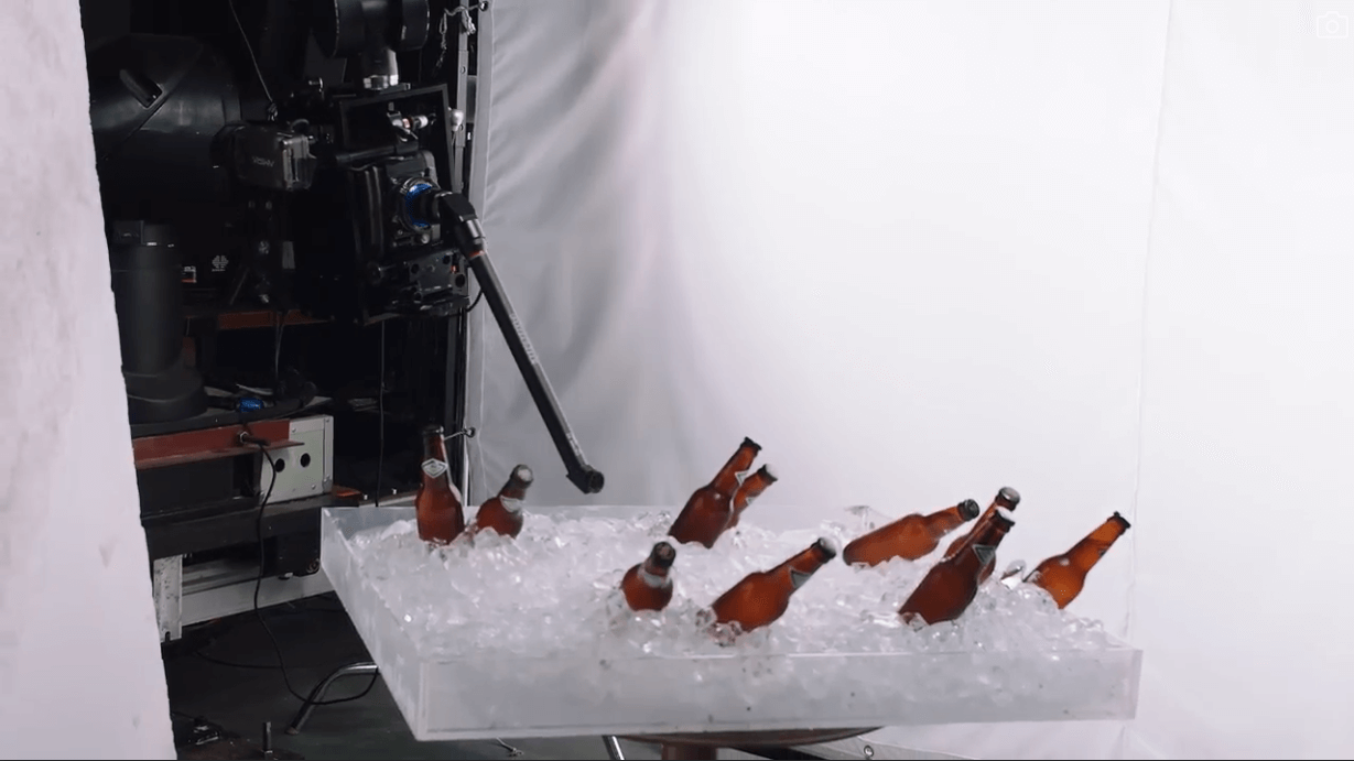A group of brown bottles in ice Description automatically generated