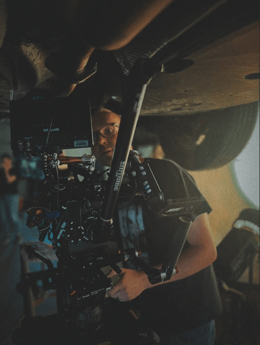 A person holding a camera Description automatically generated